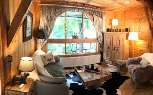 a living room with a couch and a window at Alte Mühle Appartements in Seefeld in Tirol