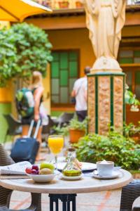 un tavolo con cibo e un bicchiere di succo d'arancia di Hostal Loreto a Denia