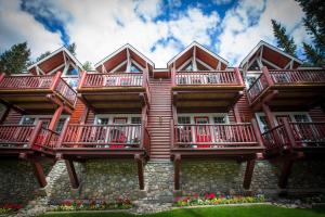 a red brick building with two red balconies at Paradise Lodge and Bungalows in Lake Louise