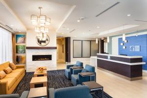 a lobby with a couch and chairs and a fireplace at Holiday Inn Express at Monterey Bay, an IHG Hotel in Seaside