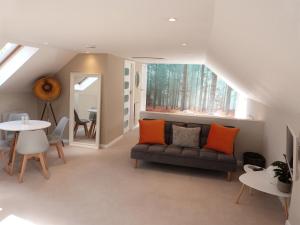 a living room with a couch and a table at The Barn, Boutique Self-Catering Apartment - Belvoir Suite in Allington