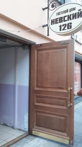 duże drewniane drzwi przed budynkiem w obiekcie Guest House Geralda on Nevskiy w Petersburgu