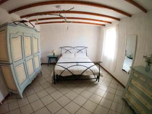 a bedroom with a bed in the corner of a room at Cà di N in Castel dʼAiano