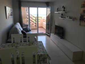 a living room with a view of a balcony at Atico con piscina privada y vistas al mar in Vera