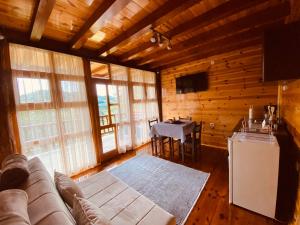 a living room with a couch and a table at FERN FARM ECO RESORT in Mojkovac