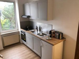 a small kitchen with a sink and a window at Ferienwohnung Zur alten Schmiede in Kottenheim