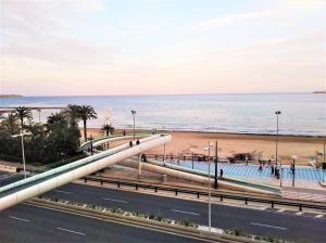 a view of the beach and a road at San Blas Apartment - Alicante City in Alicante