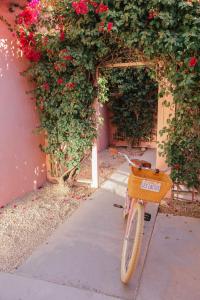 a bike parked next to a building with flowers at Les Cactus in Palm Springs