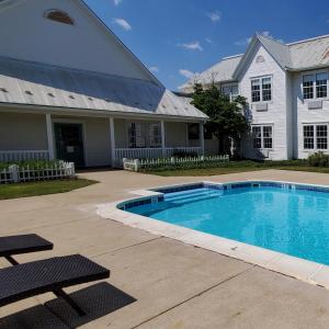 a swimming pool in front of a house at Amish Inn in Nappanee