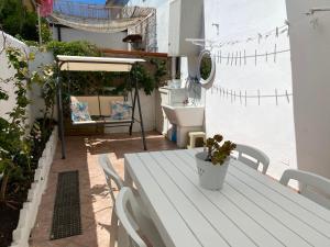 a white table and chairs on a patio at Lulù Marin Praia 2 in Praia a Mare