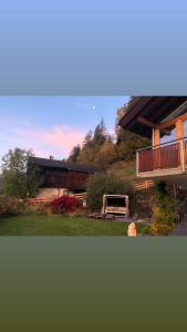 a house with a deck and a table in the yard at Ferienwohnungen Landler in San Giovanni in Val Aurina