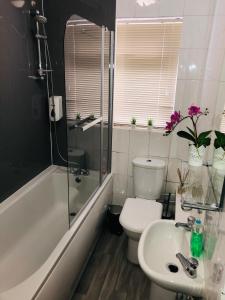 a bathroom with a sink and a toilet and a bath tub at St Marks in Northfleet