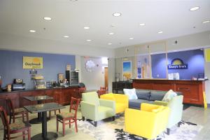 a lobby with a couch and chairs and a table at Days Inn by Wyndham Manassas in Manassas