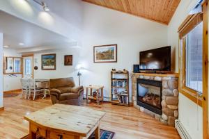 a living room with a fireplace and a tv at Estes Park Condos in Estes Park
