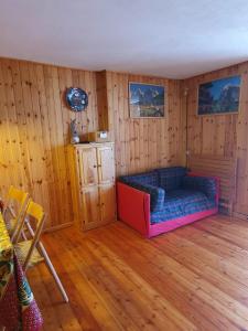 un soggiorno con divano e pareti in legno di Il Rifugio di Marcella a Challand Saint Anselme