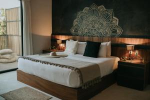 a hotel room with a bed and a lamp at Mudra Tulum in Tulum