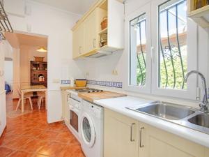 a kitchen with a sink and a washing machine at Comfortable holiday home close to the beach in La Cala de Mijas in La Cala de Mijas
