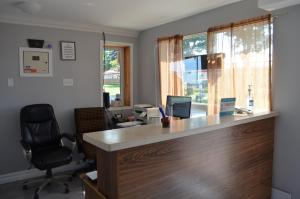 an office with a desk with a computer and a window at Studio 1 Motel in Cobourg