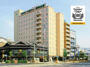 a large building on a city street with at Hotel Belleview Nagasaki Dejima in Nagasaki