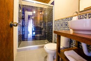 
a bathroom with a toilet, sink, and shower at Selina San Miguel de Allende in San Miguel de Allende
