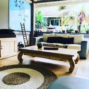 a living room with a couch and a coffee table at Villa Bali Santai in Kerobokan