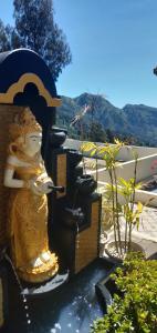 a statue of a woman drinking from a fountain at Bromo Otix Guest House in Bromo
