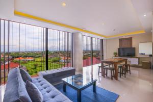 a living room with a couch and a table at Canggu Dream Village Hotel and Suites in Canggu