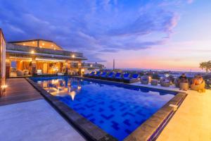 a pool on the roof of a building at Canggu Dream Village Hotel and Suites in Canggu