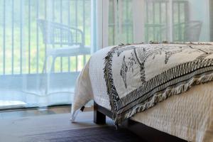 a bed in a room with a cat standing on the floor at Whispering Mountains Boutique Hotel in Zhangjiajie