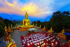 a large group of people sitting in front of a temple at Vogue Pattaya Hotel in Pattaya