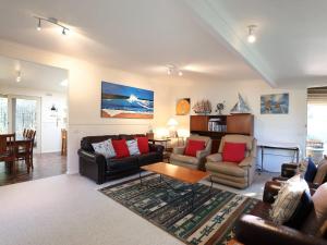 a living room with couches and a table at Back Beach Hideaway in Blairgowrie
