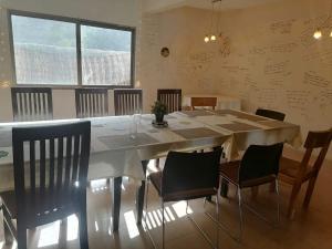 a dining room with a large white table and chairs at Indus View Hotel Skardu in Skardu