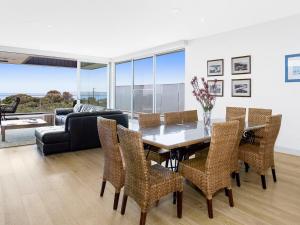 a dining room with a table and chairs and a couch at Bayview in Rye