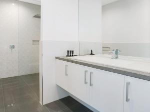 a white bathroom with a sink and a mirror at Bayview in Rye +16 photos