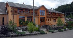 a house with flowers on the balconies of it at Penzión pod Kýčerou in Zuberec