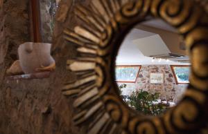 a mirror reflection of a living room with a couch at Hotel Danila in Portoferraio