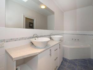 a white bathroom with two sinks and a bath tub at Poolside Sorrento in Sorrento +11 photos