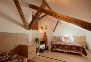 a attic bedroom with a bed and a dresser at Guest House 1568 in Cluj-Napoca