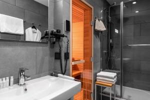 a bathroom with a sink and a shower at Hotel Residence in Yekaterinburg