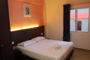 Postel nebo postele na pokoji v ubytování Bayu View Hotel Melaka