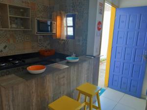 a kitchen with two bowls on the counter and two stools at Hostel e Pousada Boa Vista in Recife