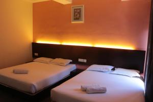 Postel nebo postele na pokoji v ubytování Bayu View Hotel Melaka + 19 fotografií