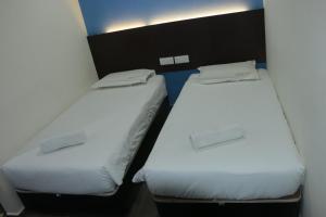 Postel nebo postele na pokoji v ubytování Bayu View Hotel Melaka