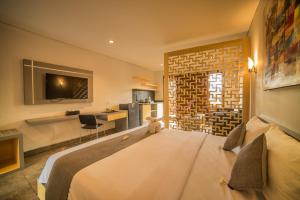 a bedroom with a large bed in a room at Grand Kesambi Resort and Villas in Kerobokan