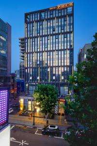 a tall building with a sign on top of it at Hotel POCO Seongsu in Seoul