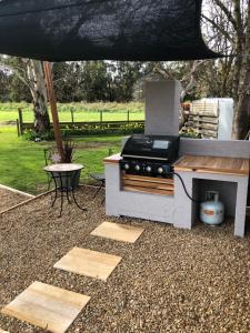 cocina al aire libre con fogones y mesa en Creswick Motel en Creswick