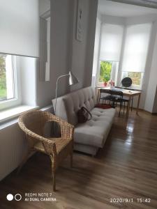 a living room with a couch and a table at Herman View Apartment in Grudziądz