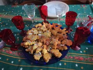 a plate of food on a christmas table at Rubilia Rooms Pompei in Torre Annunziata +36 photos