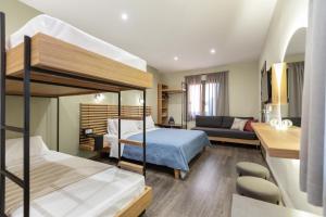 a bedroom with two bunk beds and a living room at Pegasus Rooms in Korinthos