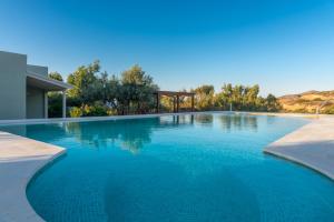 a swimming pool with blue water in a house at NEW - Villa Manika - 3BR 3BA Pool in Agia Fotia